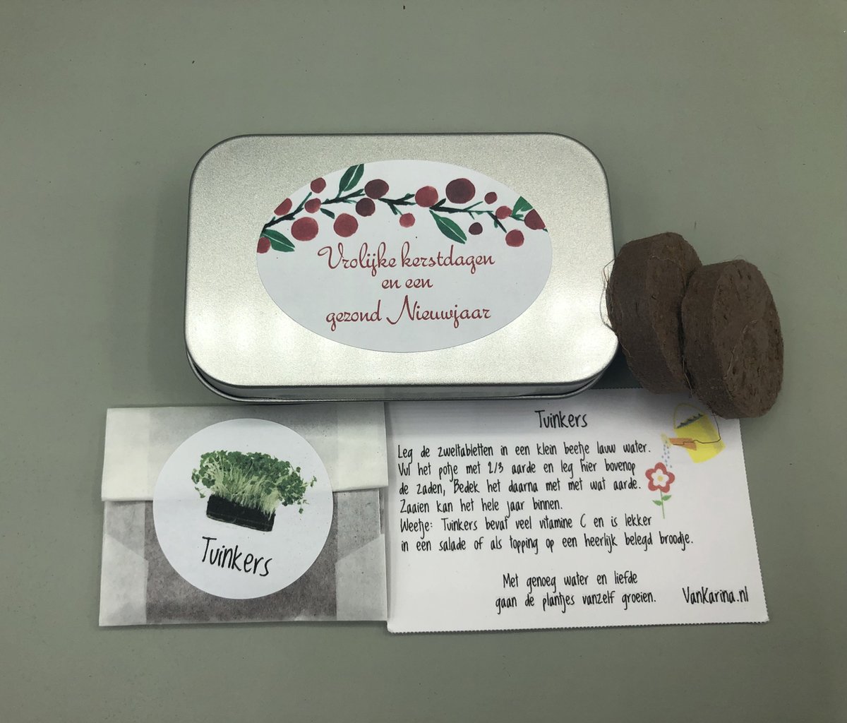 Vrolijke kerstdagen en een gezond nieuwjaar, aluminium blikje met aardetabletten en een zakje tuinkers.